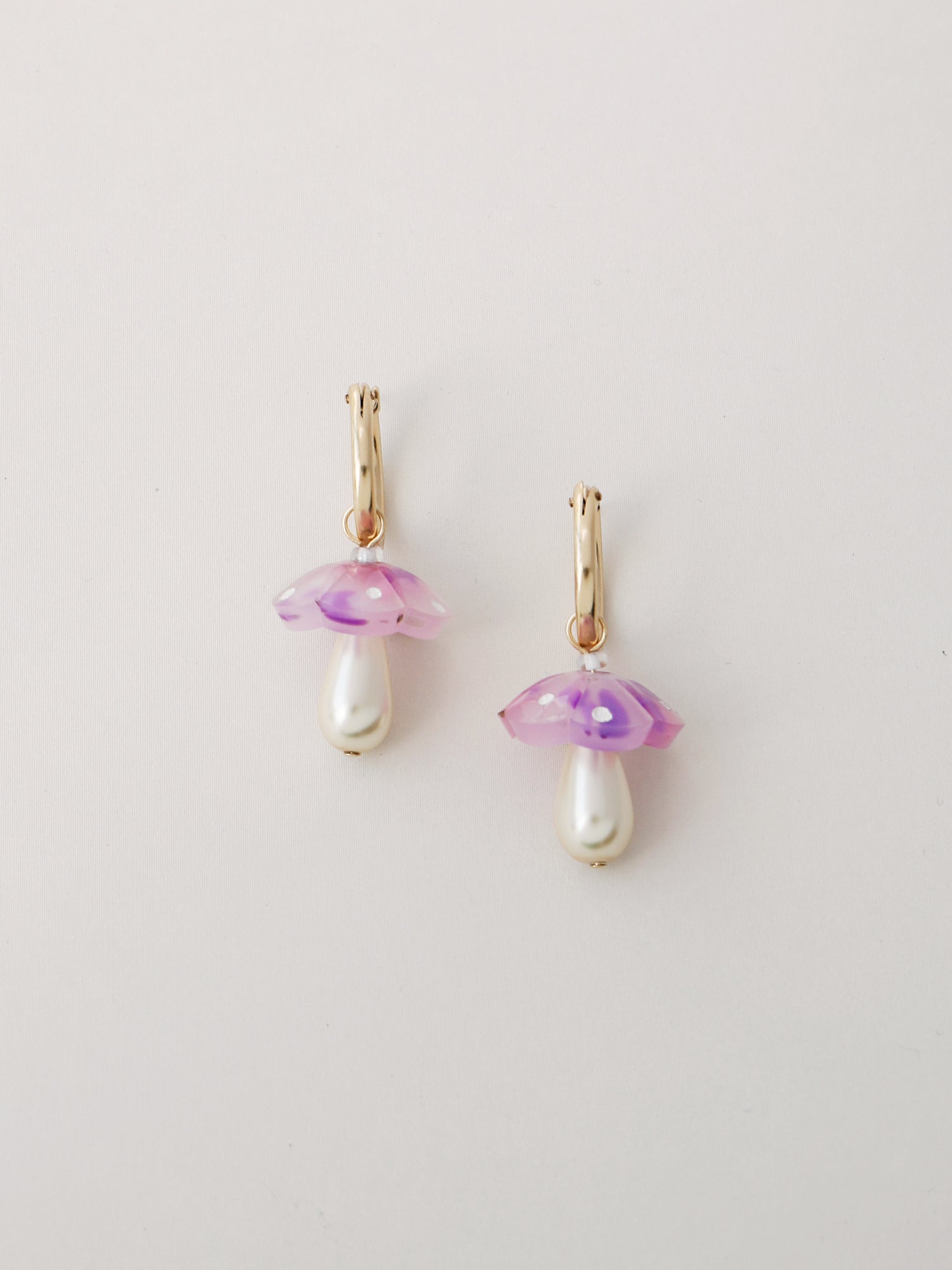 Mushroom charm hoops in lavender speckle. Made from heat-formed speckled acrylic with hand-inked details, and finished off with high quality Czech glass pearls and 14k gold-filled findings.