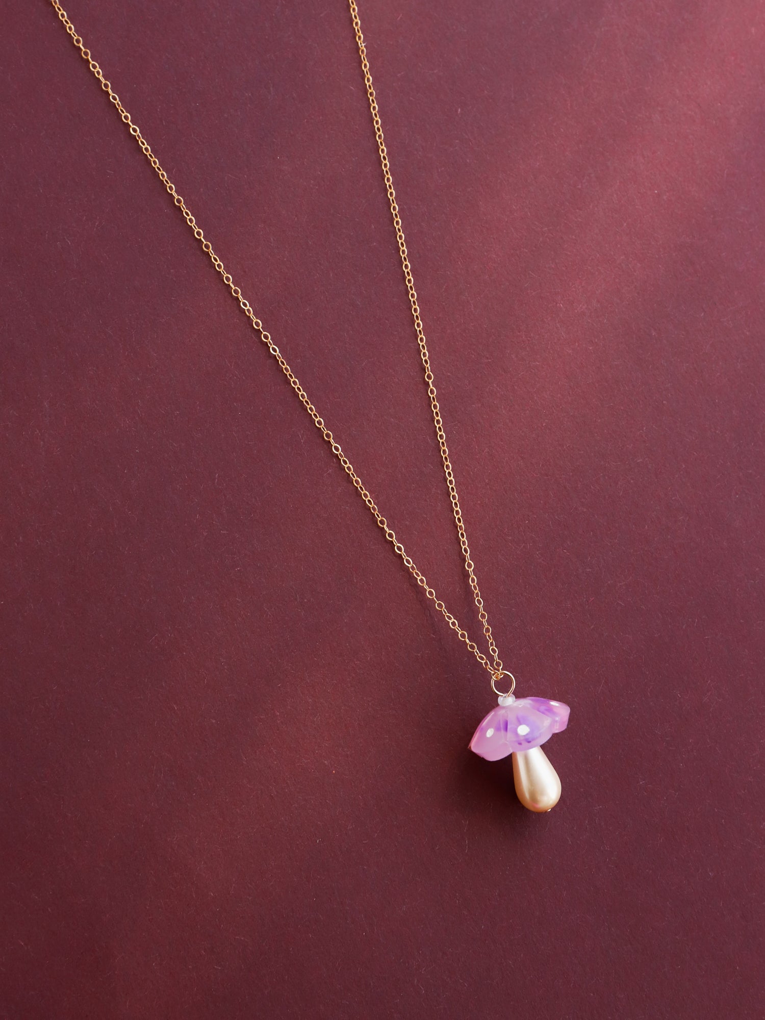 Lavender mushroom pendant necklace. Made from heat-formed speckled acrylic with hand-inked details and finished off with a high quality Czech glass pearl. Pendant is hung on a high quality 50cm 14k gold-filled chain. Handmade in the UK by Wolf & Moon.