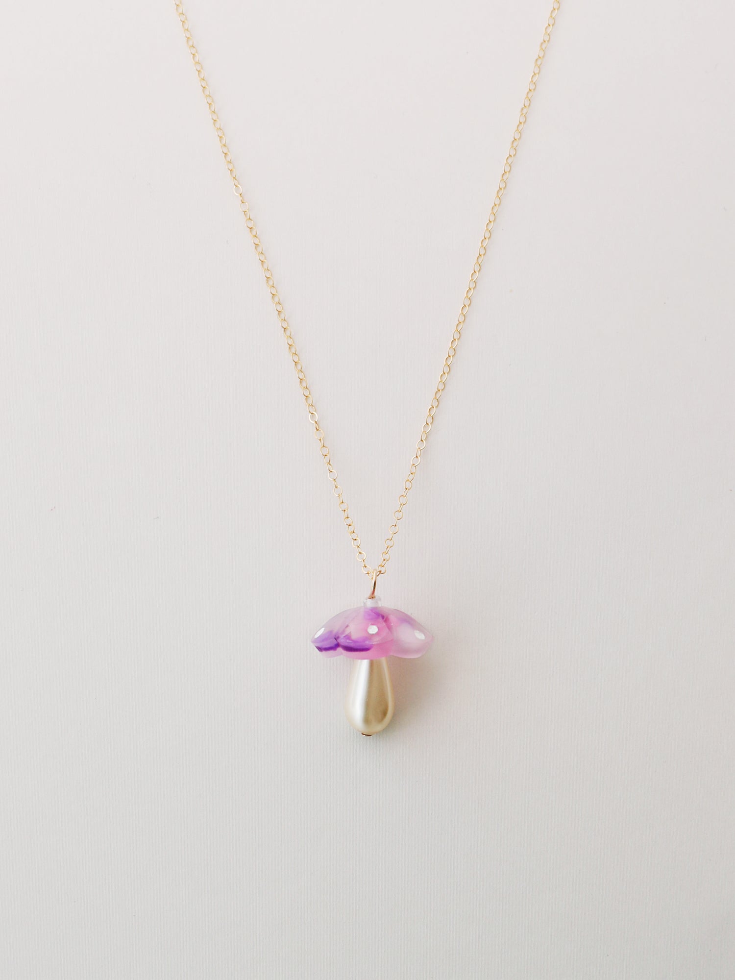 Lavender mushroom pendant necklace. Made from heat-formed speckled acrylic with hand-inked details and finished off with a high quality Czech glass pearl. Pendant is hung on a high quality 50cm 14k gold-filled chain. Handmade in the UK by Wolf & Moon.