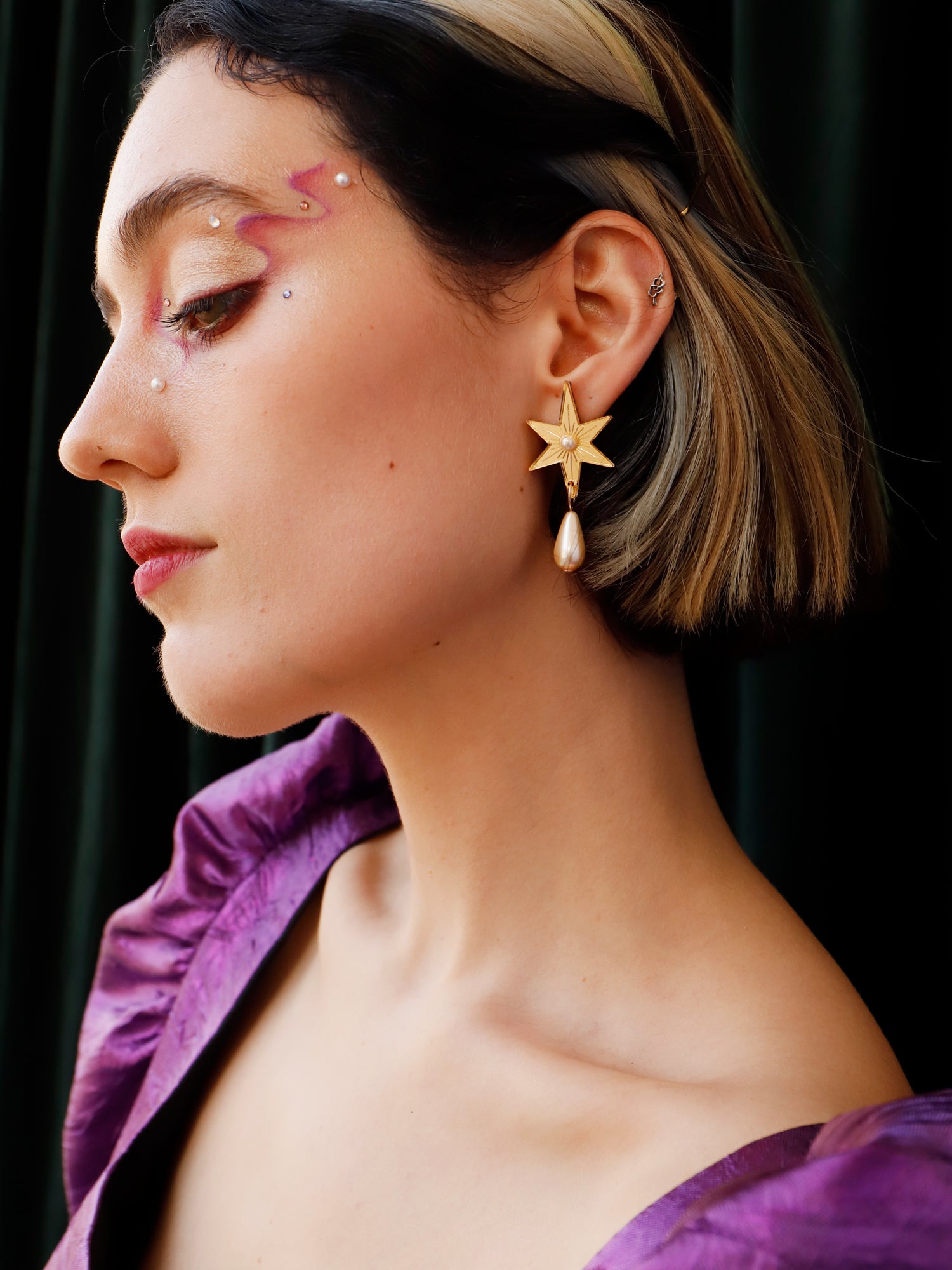 Statement star studs made with gold mirrored acrylic, embellished with glass pearl and bead details. Handmade in London by Wolf & Moon.