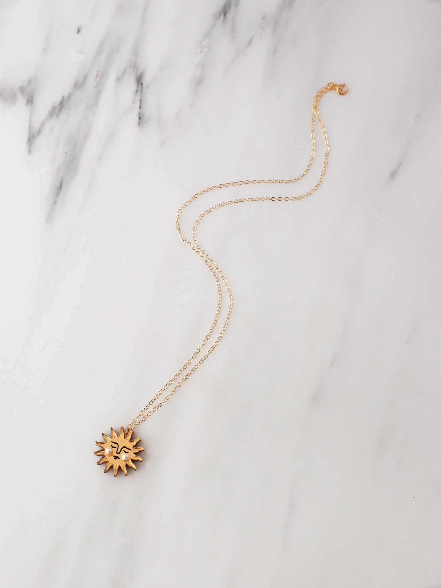 Sun Necklace in Gold. Pendant necklace made with laser cut acrylic, Czech glass pearls and hand inked details. Handmade in the UK by Wolf & Moon.